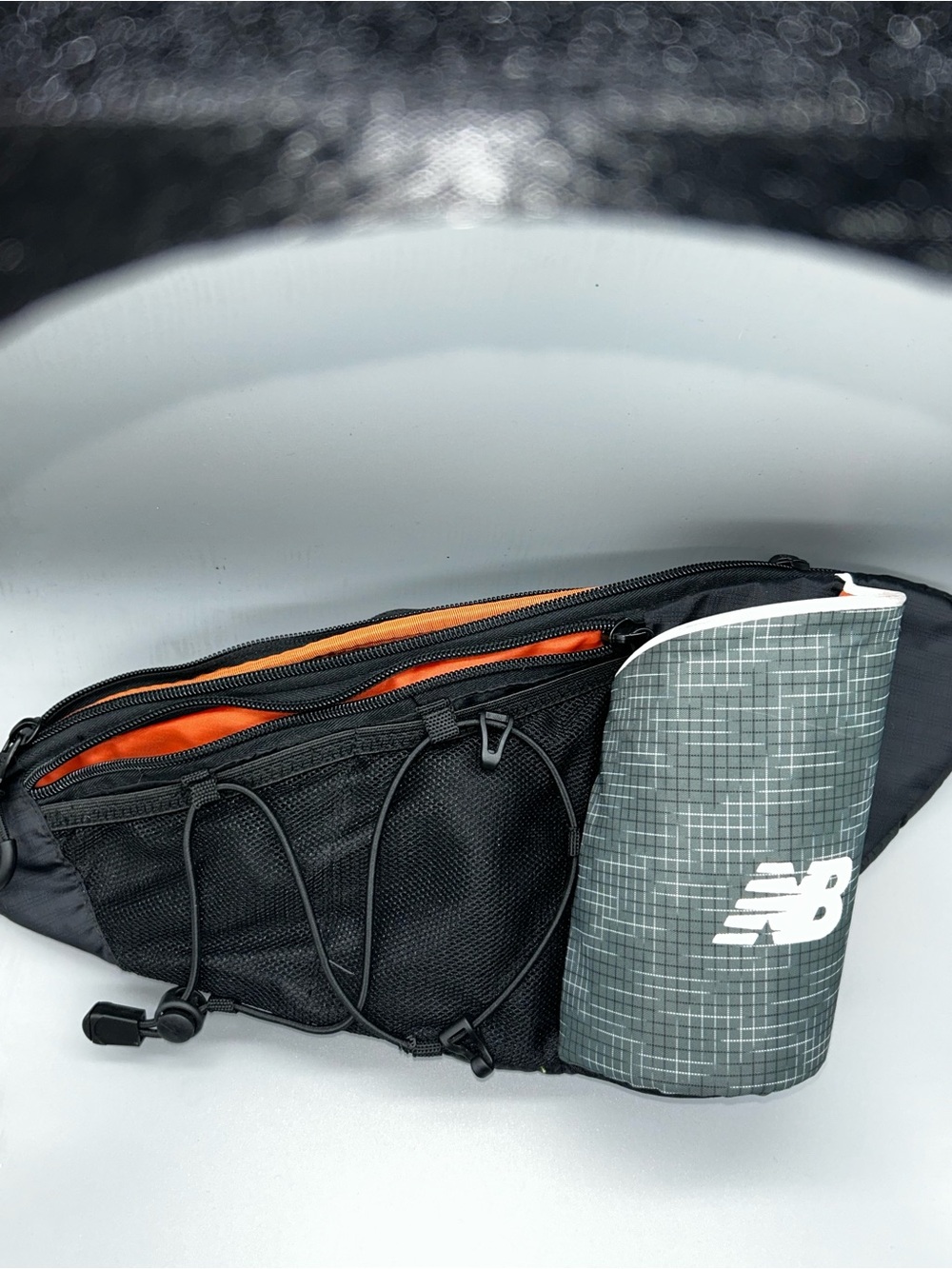 New Balance Black Belt Bag with Orange Lining and Gray Reflective Bottle Sleeve